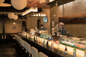 Restaurant interior, staff members working behind the bar