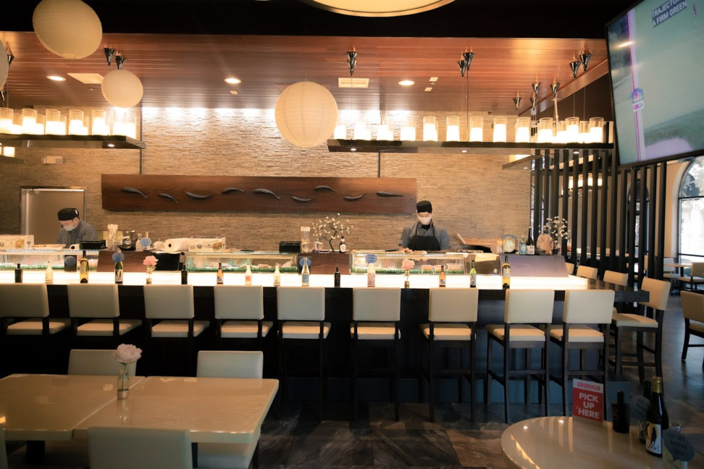 Interior, staff members working behind the bar